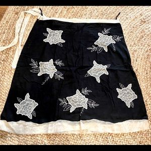 Black cotton skirt with toile flowers. Side zipper and toile bow/belt